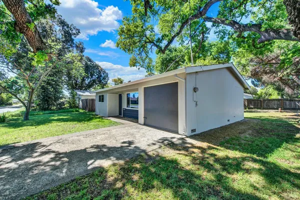 a front view of a house with a garden and yard