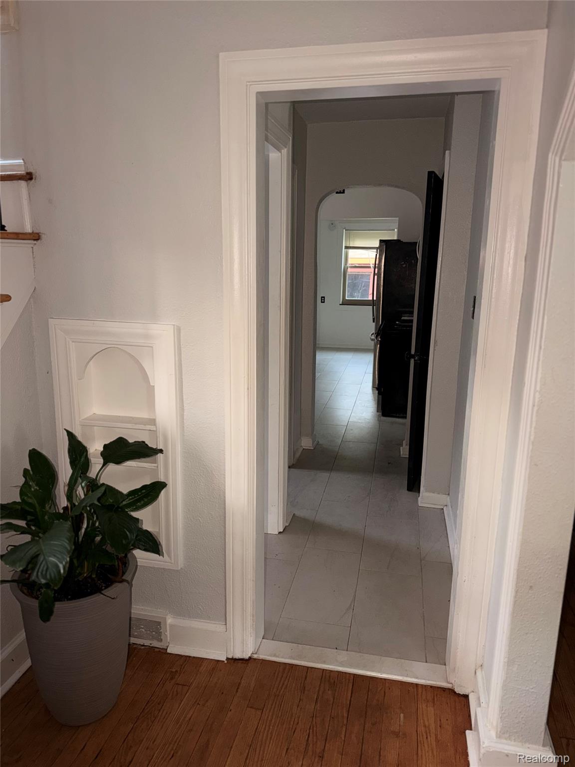 3914 Balfour Road Detroit, MI 48224 - Photo 10 of 24 Hardwood flooring, recessed wall niche, and doorway with substantial trim
