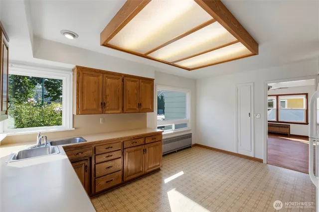 a view of a kitchen with a sink and cabinets