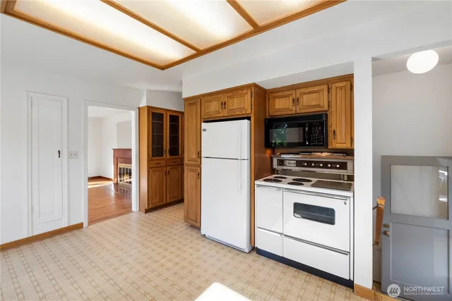a kitchen with stainless steel appliances a stove a refrigerator and a microwave