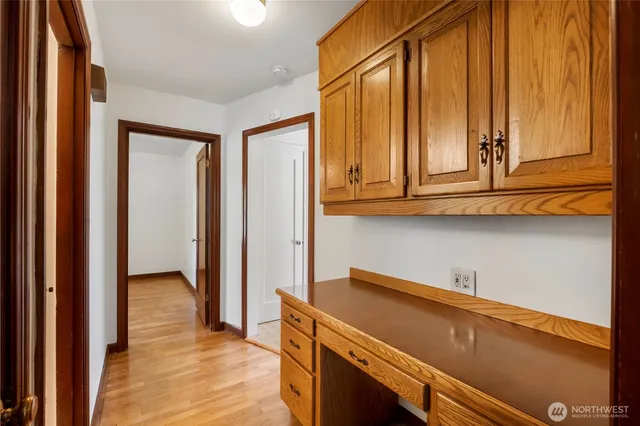 a kitchen with wooden cabinets and a window