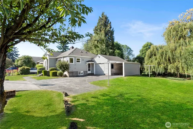 a house with huge green field in front of it