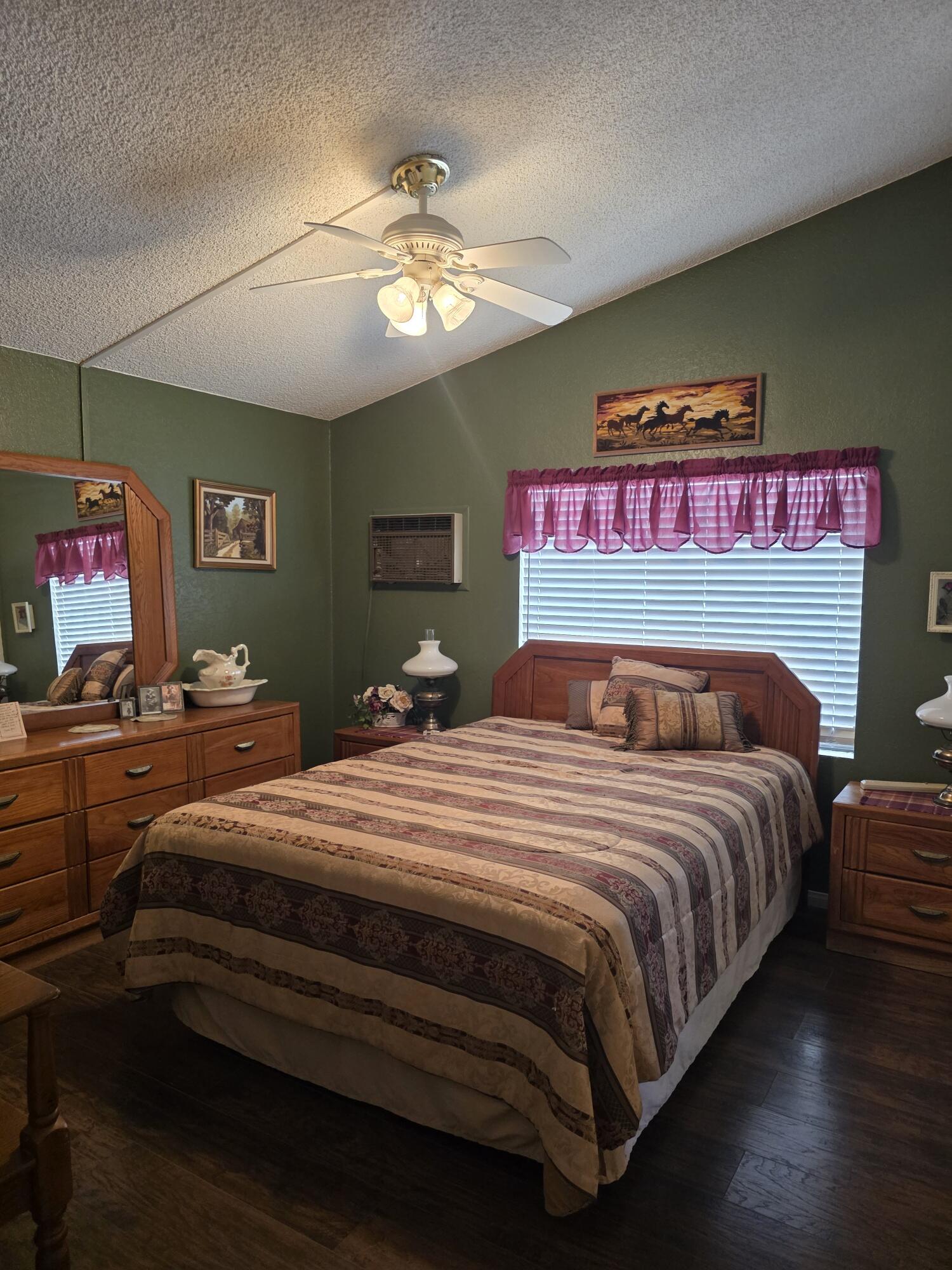 10595 Hot Mineral Spa Road, Unit 228 Niland, CA 92257 - Photo 12 of 38 a bedroom with bed and a chandelier