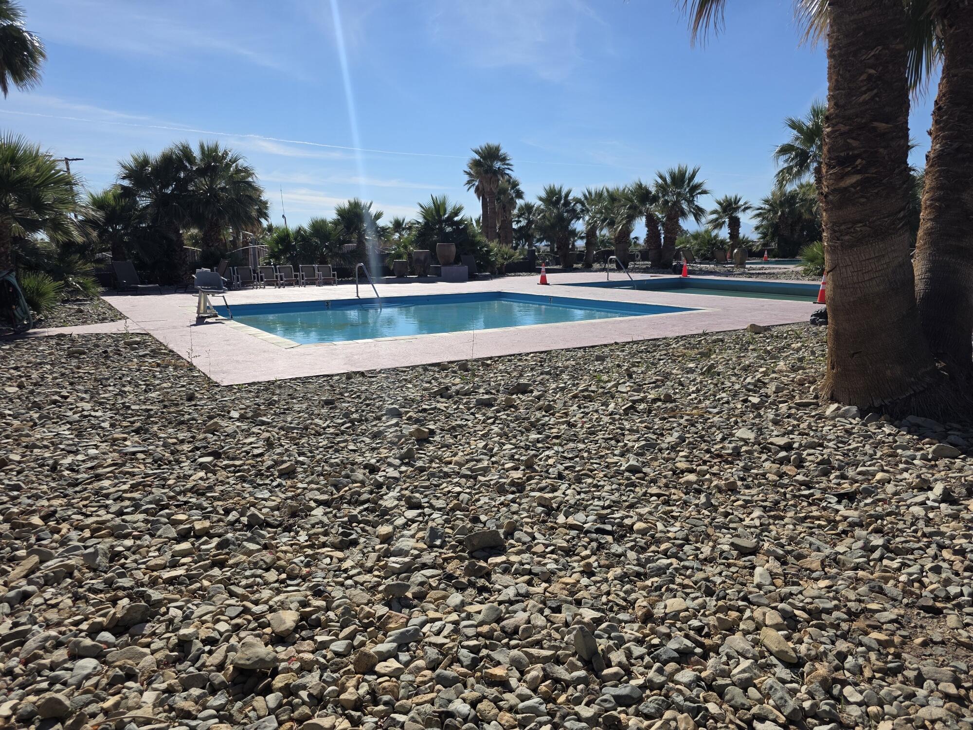 10595 Hot Mineral Spa Road, Unit 228 Niland, CA 92257 - Photo 25 of 38 a view of a swimming pool and a yard