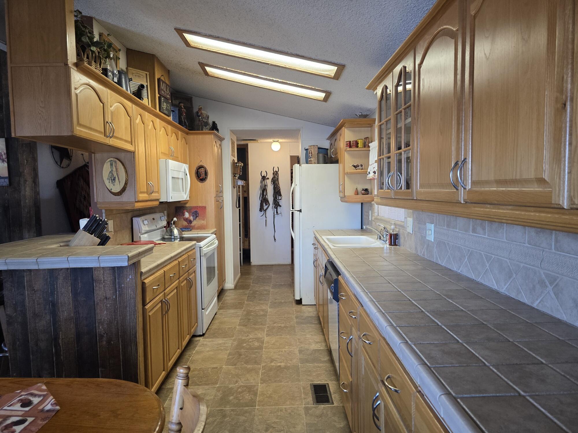 10595 Hot Mineral Spa Road, Unit 228 Niland, CA 92257 - Photo 4 of 38 a kitchen with a sink stove and cabinets