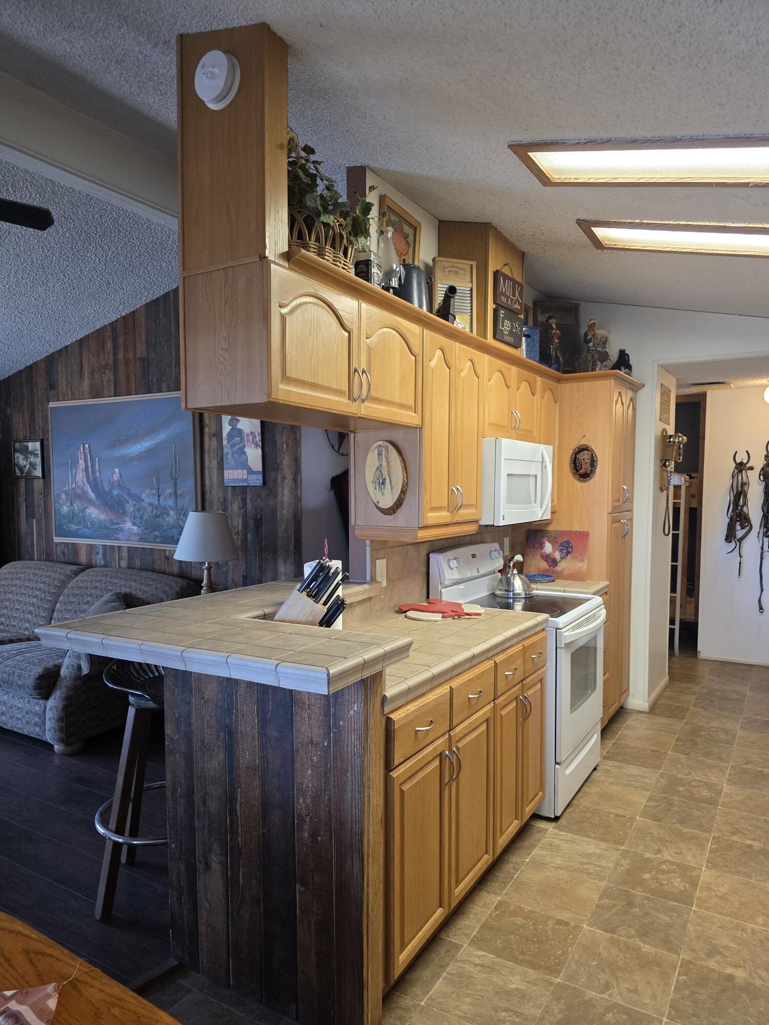 10595 Hot Mineral Spa Road, Unit 228 Niland, CA 92257 - Photo 6 of 38 a kitchen with a sink stove and cabinets