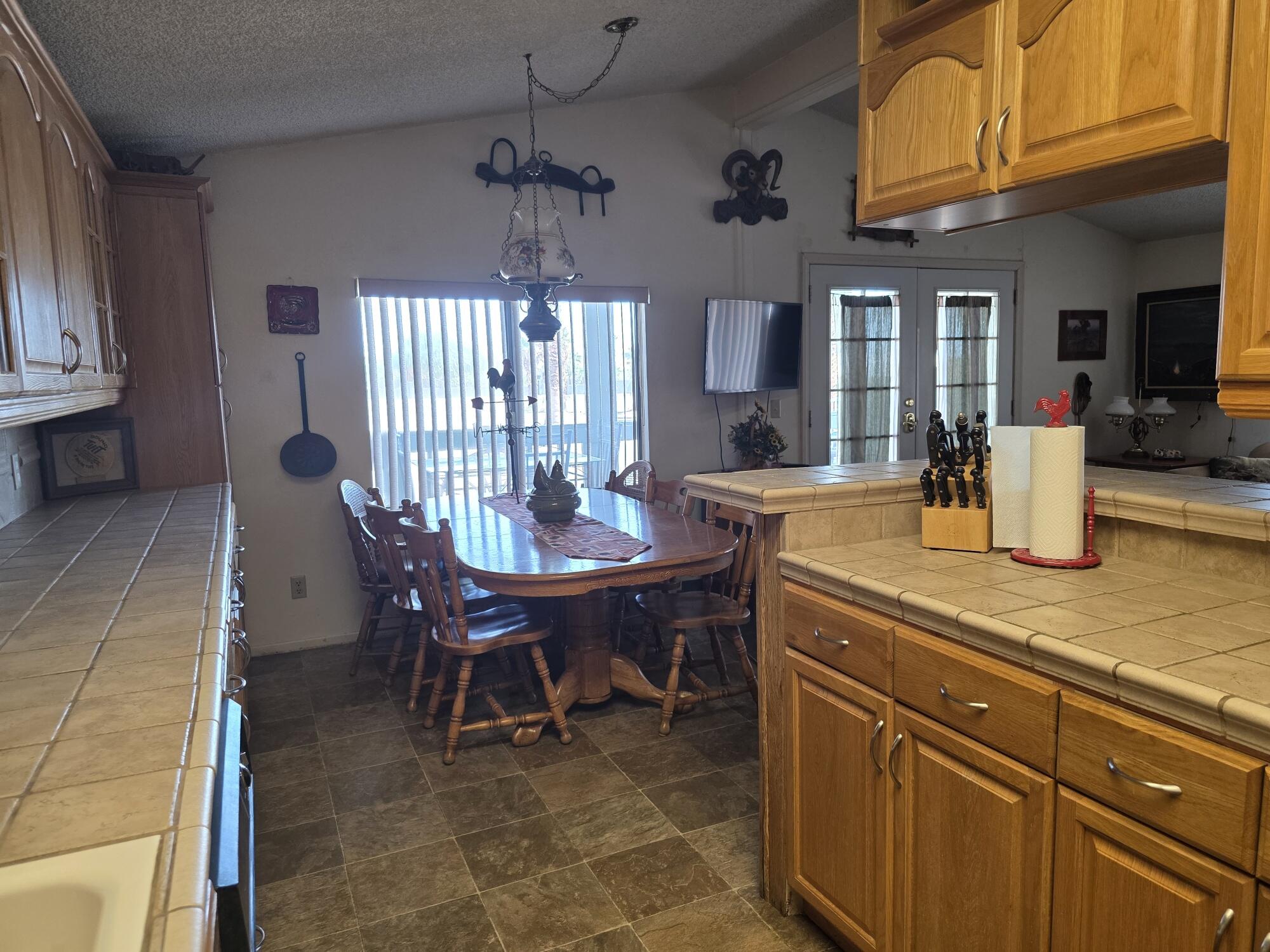 10595 Hot Mineral Spa Road, Unit 228 Niland, CA 92257 - Photo 7 of 38 a dining room with a wooden table and chairs