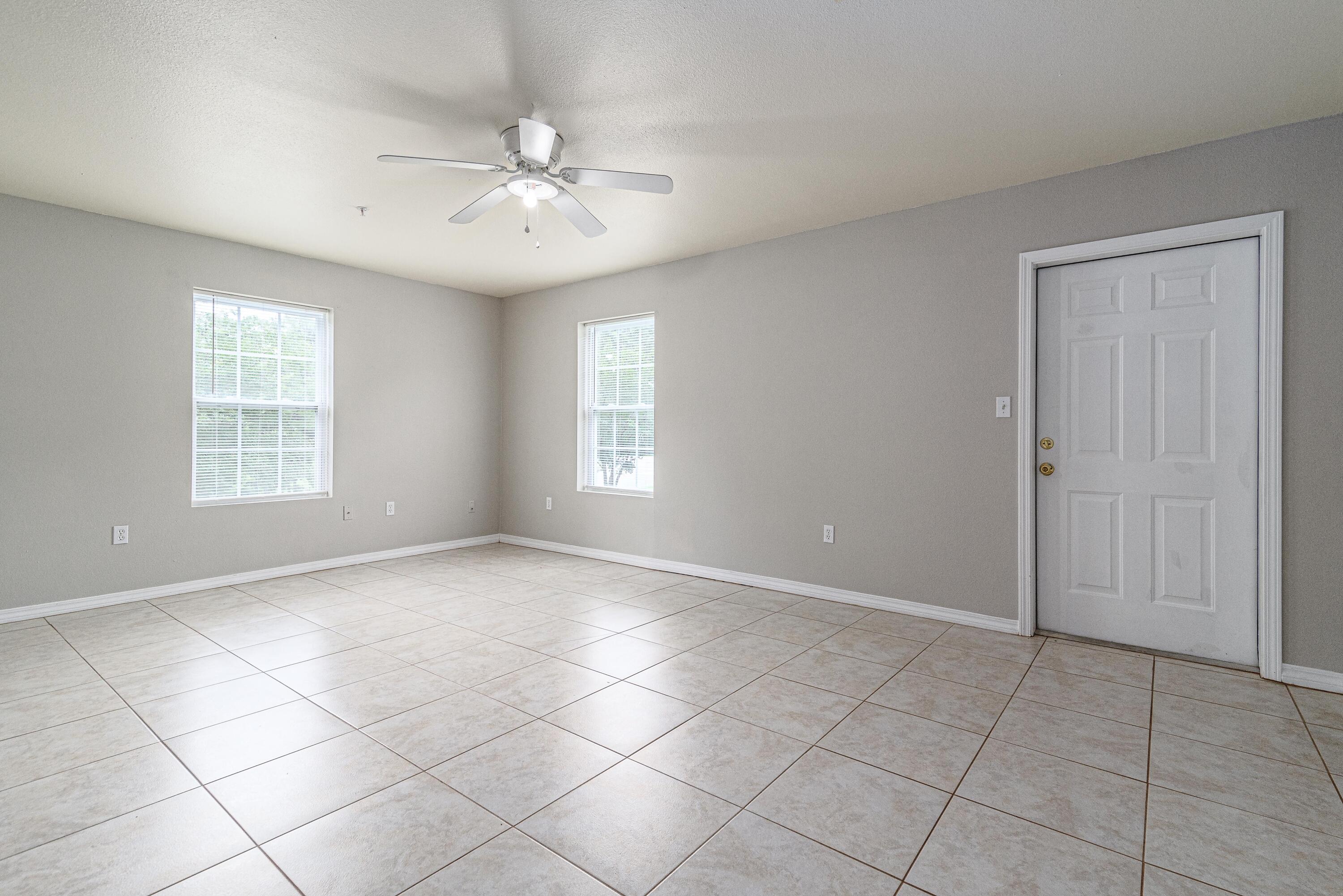 100 Corwin Drive, Unit 100 Crestview, FL 32539 - Photo 13 of 30 an empty room with windows and fan