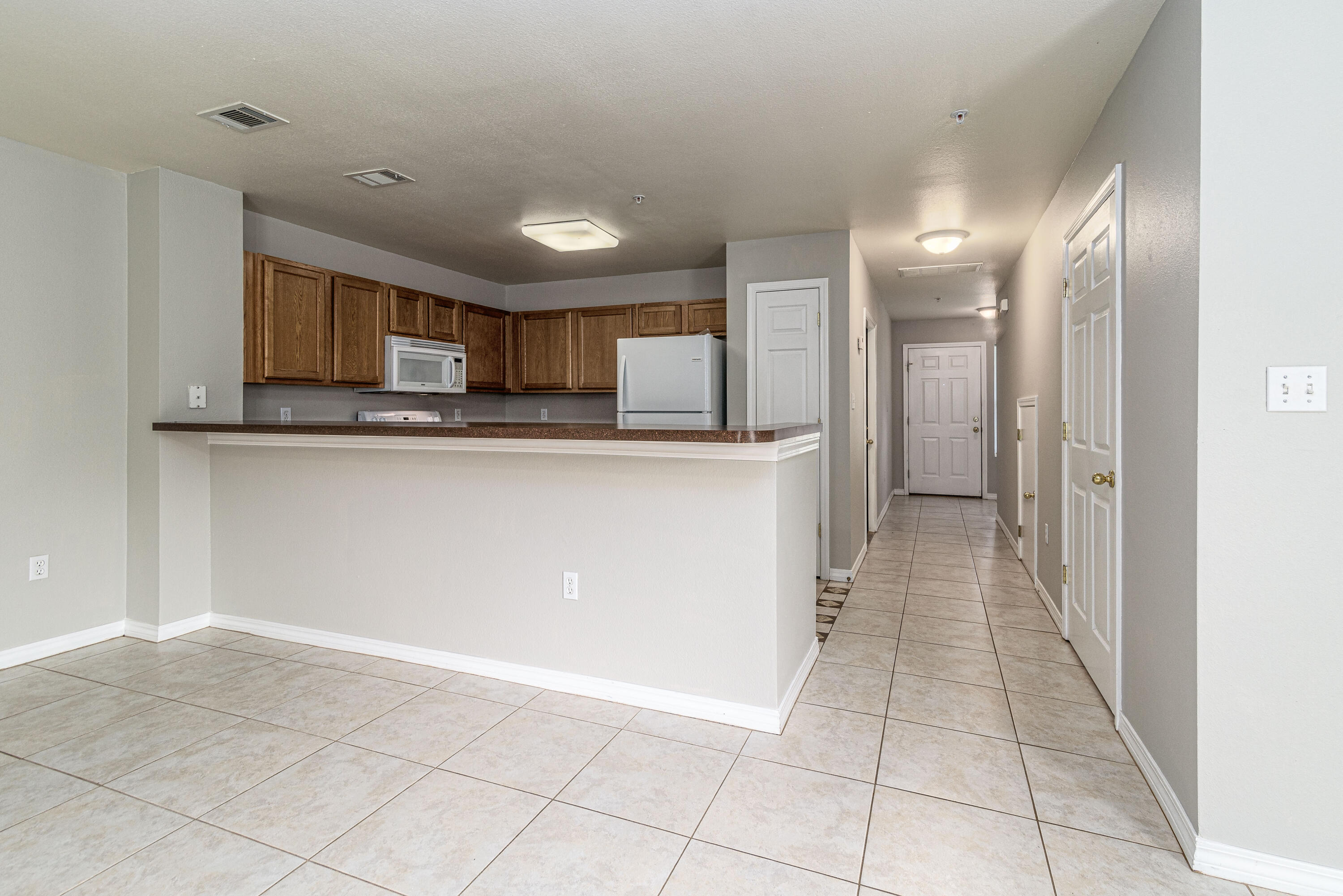 100 Corwin Drive, Unit 100 Crestview, FL 32539 - Photo 14 of 30 a kitchen with stainless steel appliances granite countertop a refrigerator and a sink