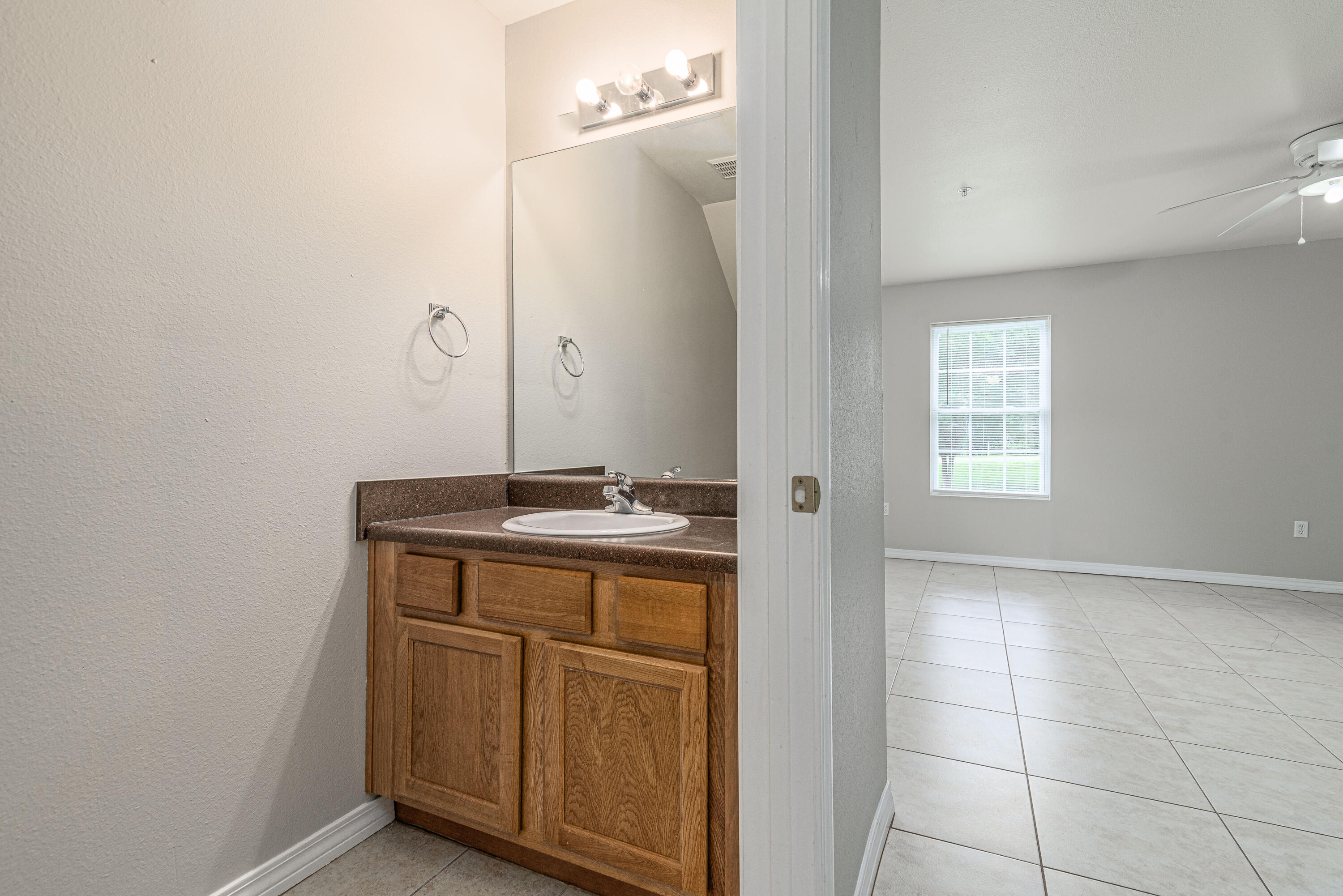 100 Corwin Drive, Unit 100 Crestview, FL 32539 - Photo 16 of 30 a bathroom with a sink a vanity and a mirror