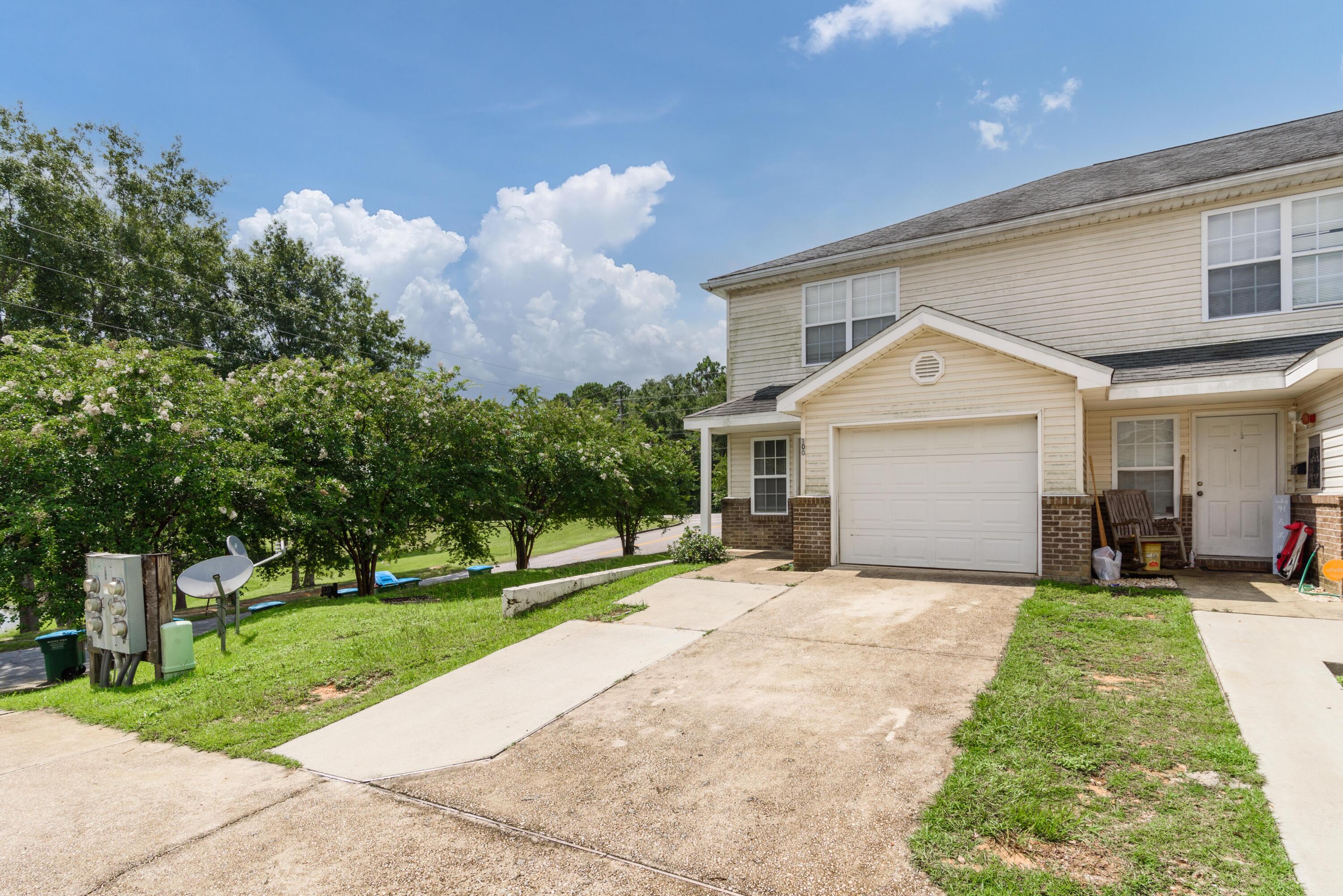 100 Corwin Drive, Unit 100 Crestview, FL 32539 - Photo 2 of 30 a front view of a house with a yard and garage