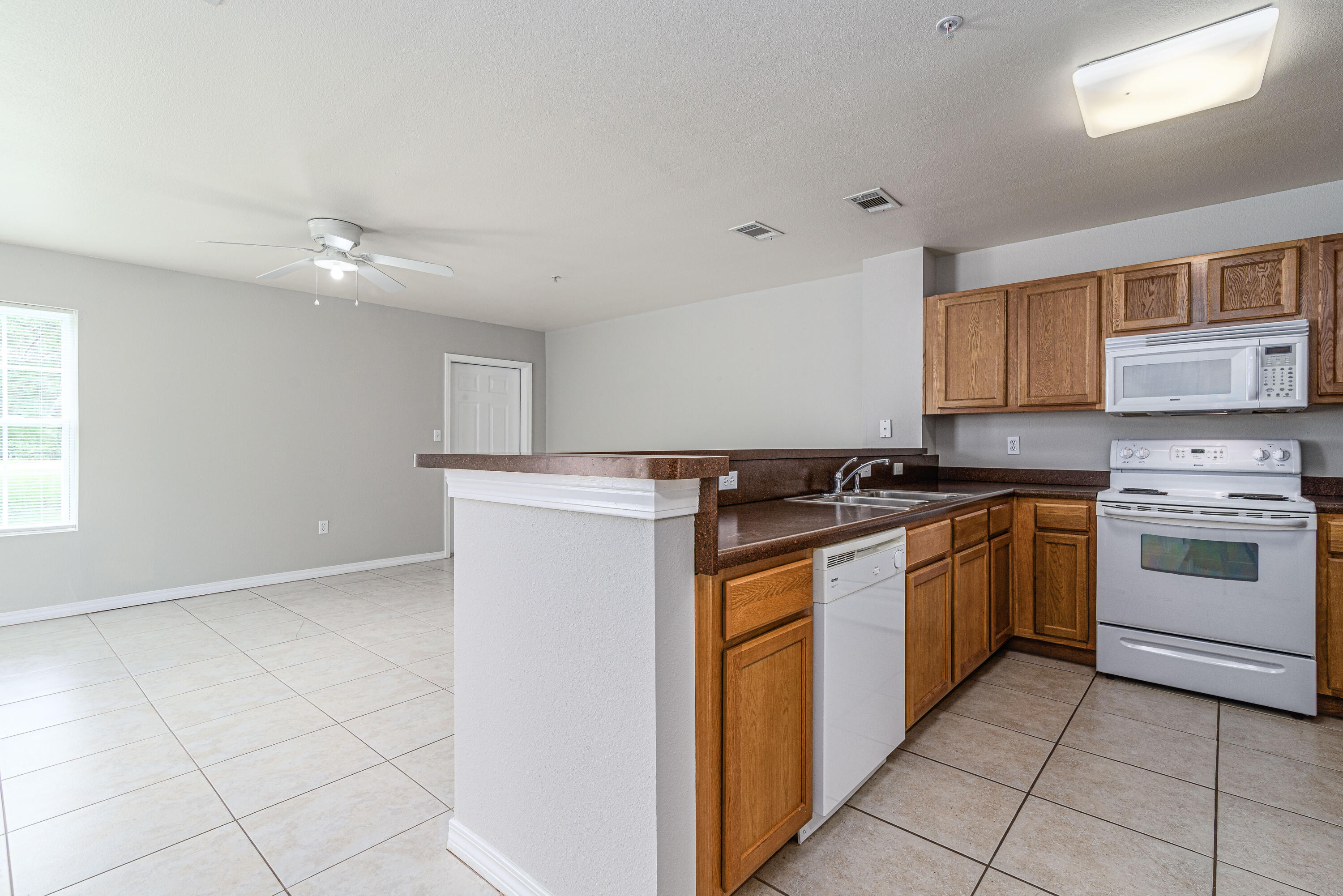 100 Corwin Drive, Unit 100 Crestview, FL 32539 - Photo 6 of 30 a kitchen with a stove sink and cabinets