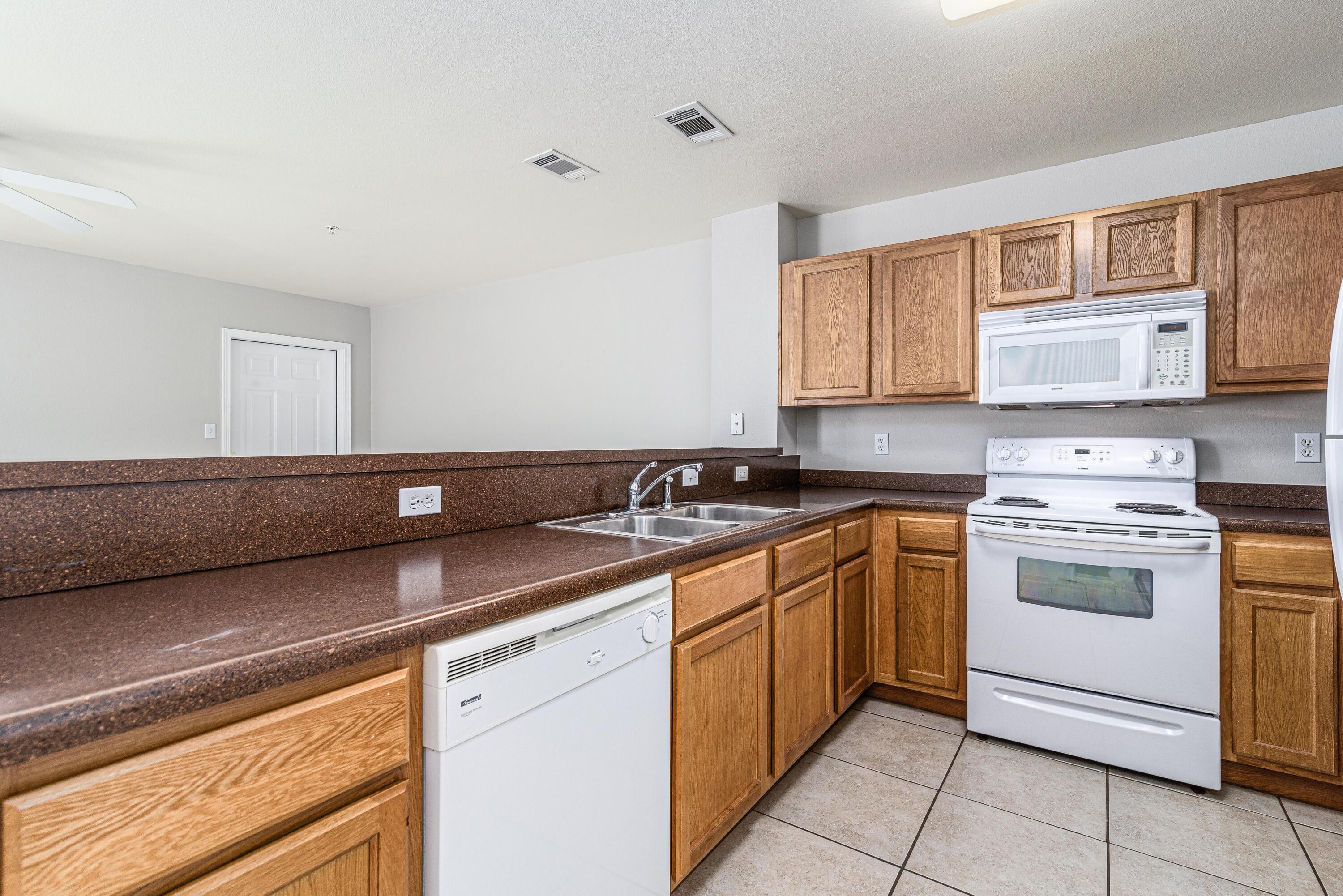 100 Corwin Drive, Unit 100 Crestview, FL 32539 - Photo 7 of 30 a kitchen with a sink cabinets and window