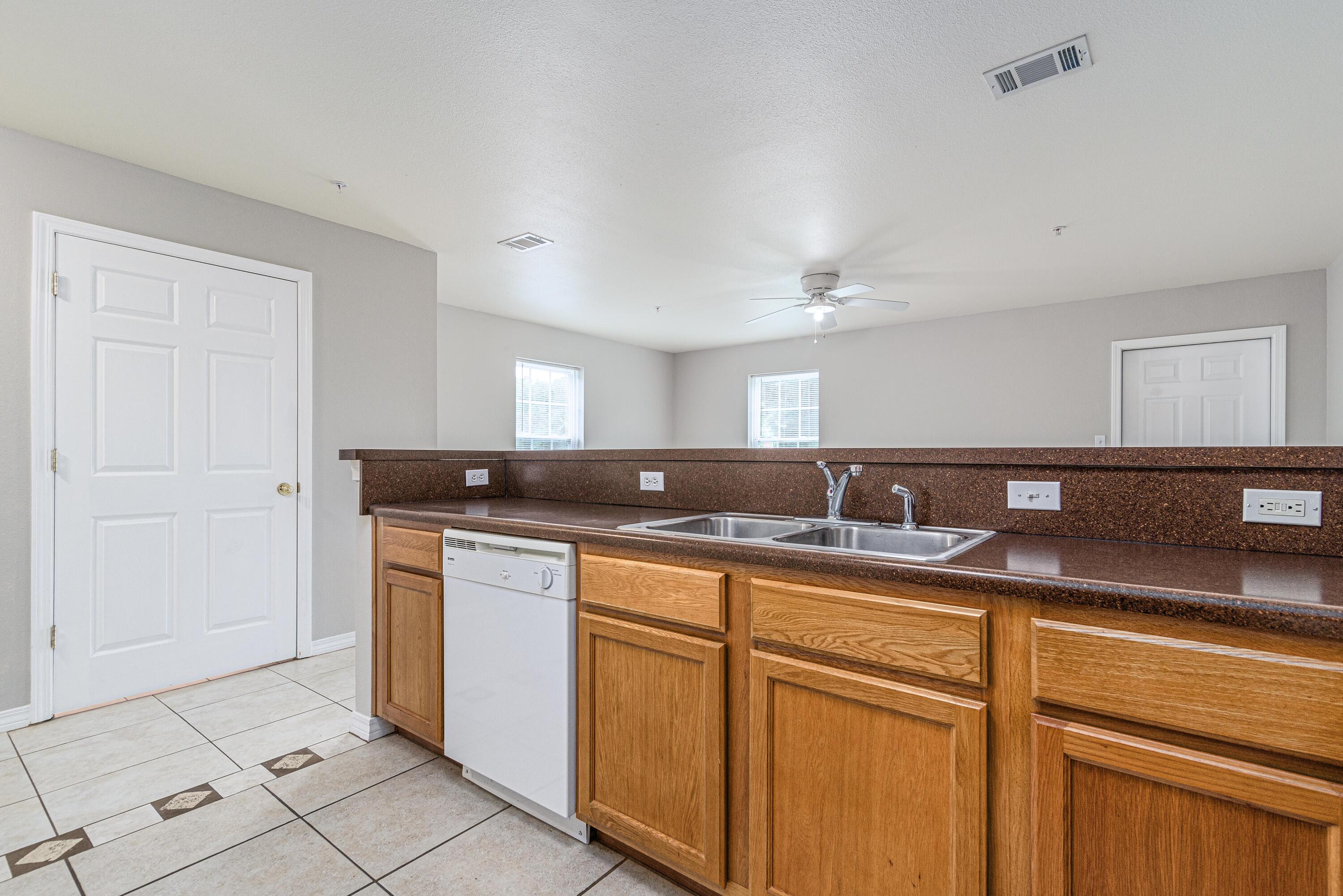 100 Corwin Drive, Unit 100 Crestview, FL 32539 - Photo 9 of 30 a kitchen with granite countertop a sink and cabinets