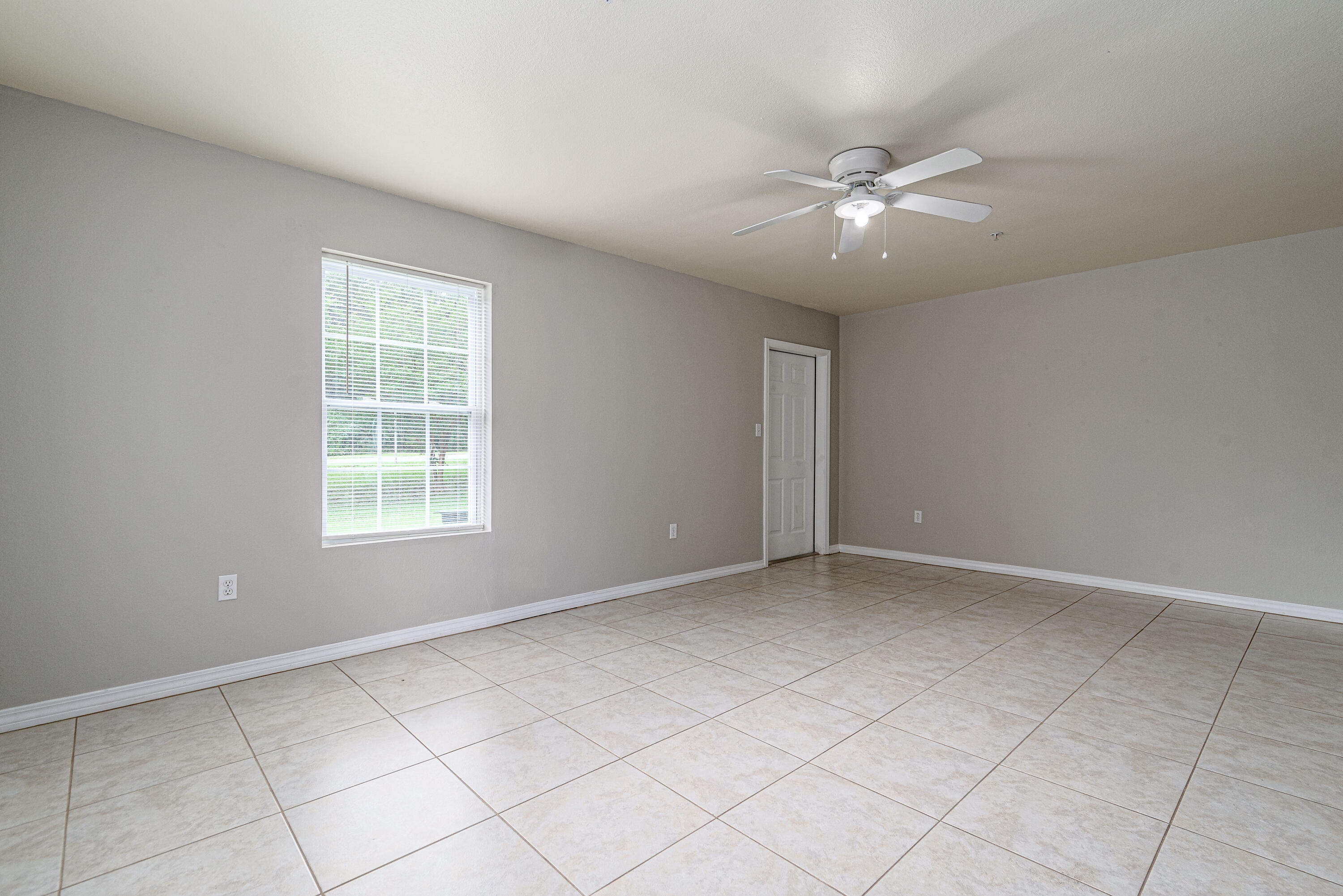 100 Corwin Drive, Unit 100 Crestview, FL 32539 - Photo 10 of 30 an empty room with windows and fan