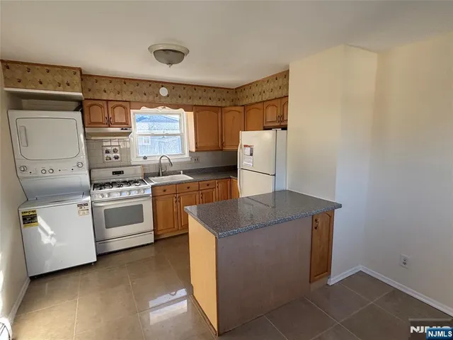 a kitchen with a stove and a refrigerator