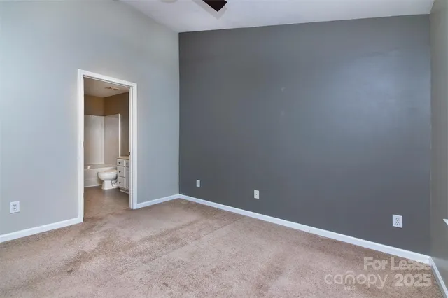 a view of an empty room and closet area