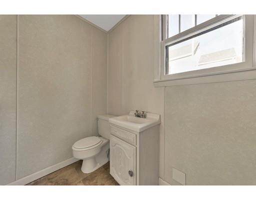 35 Perkins Street Springfield, MA 01118 - Photo 15 of 23 a bathroom with a toilet a sink and a window
