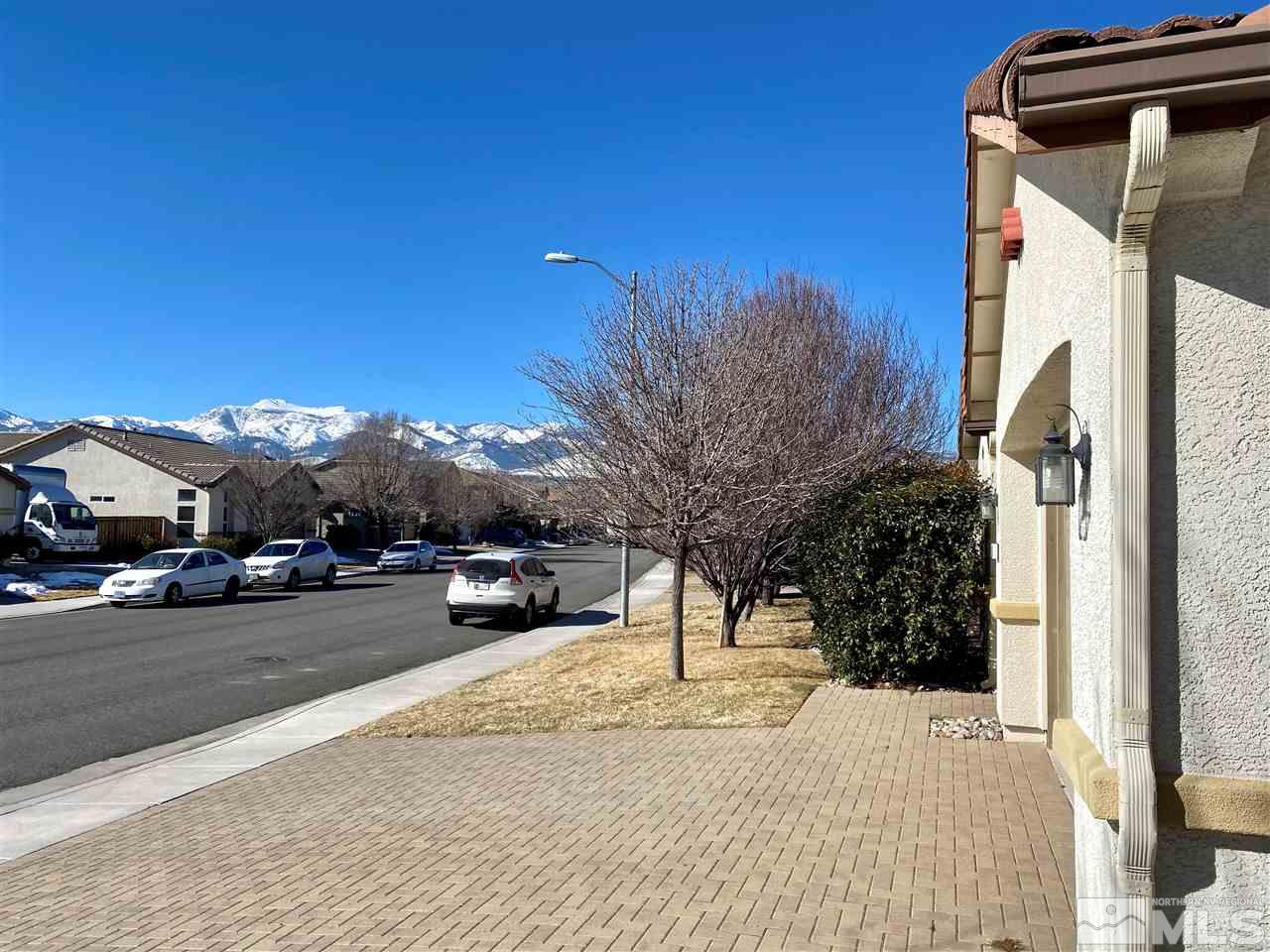 445 Pesaro Way Reno, NV 89521 - Photo 24 of 24 a view of a street with a cars parked in front of it