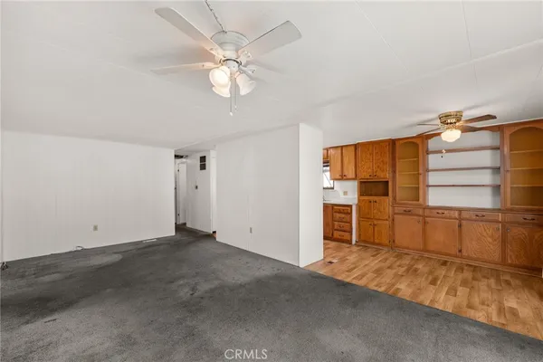 an empty room with closet and windows