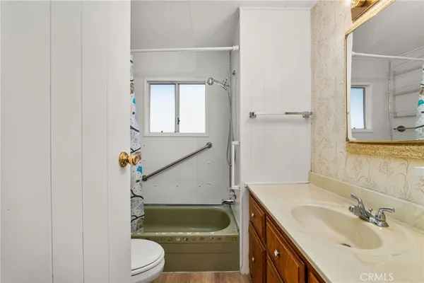 a bathroom with a sink a toilet and tub