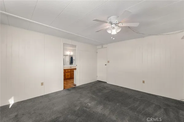 an empty room with closet and window