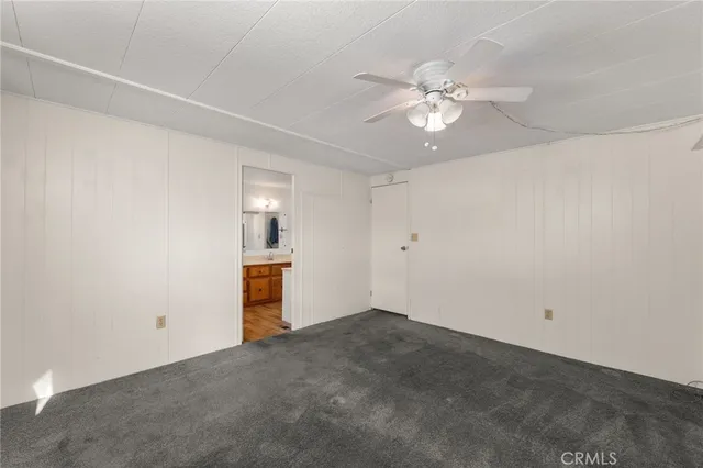 an empty room with closet and window