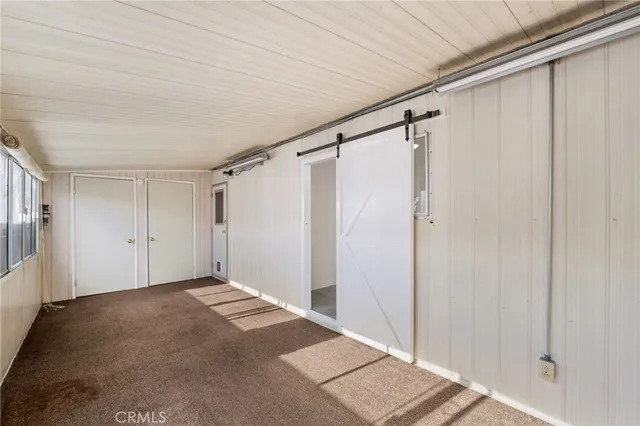 a view of a house with a wooden fence