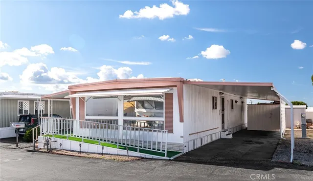 a view of a patio with dining table and chairs with floor to ceiling window
