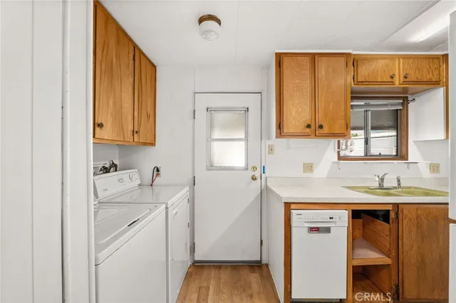 a kitchen with a sink cabinets and wooden floor