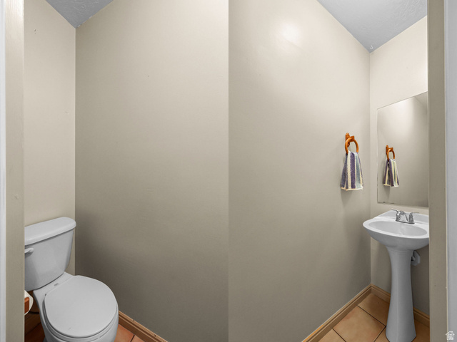 142 East 2675th Street South Clearfield, UT 84015 - Photo 18 of 49 Compact powder room featuring a pedestal sink with chrome fixtures, a wall-mounted mirror, and tile flooring