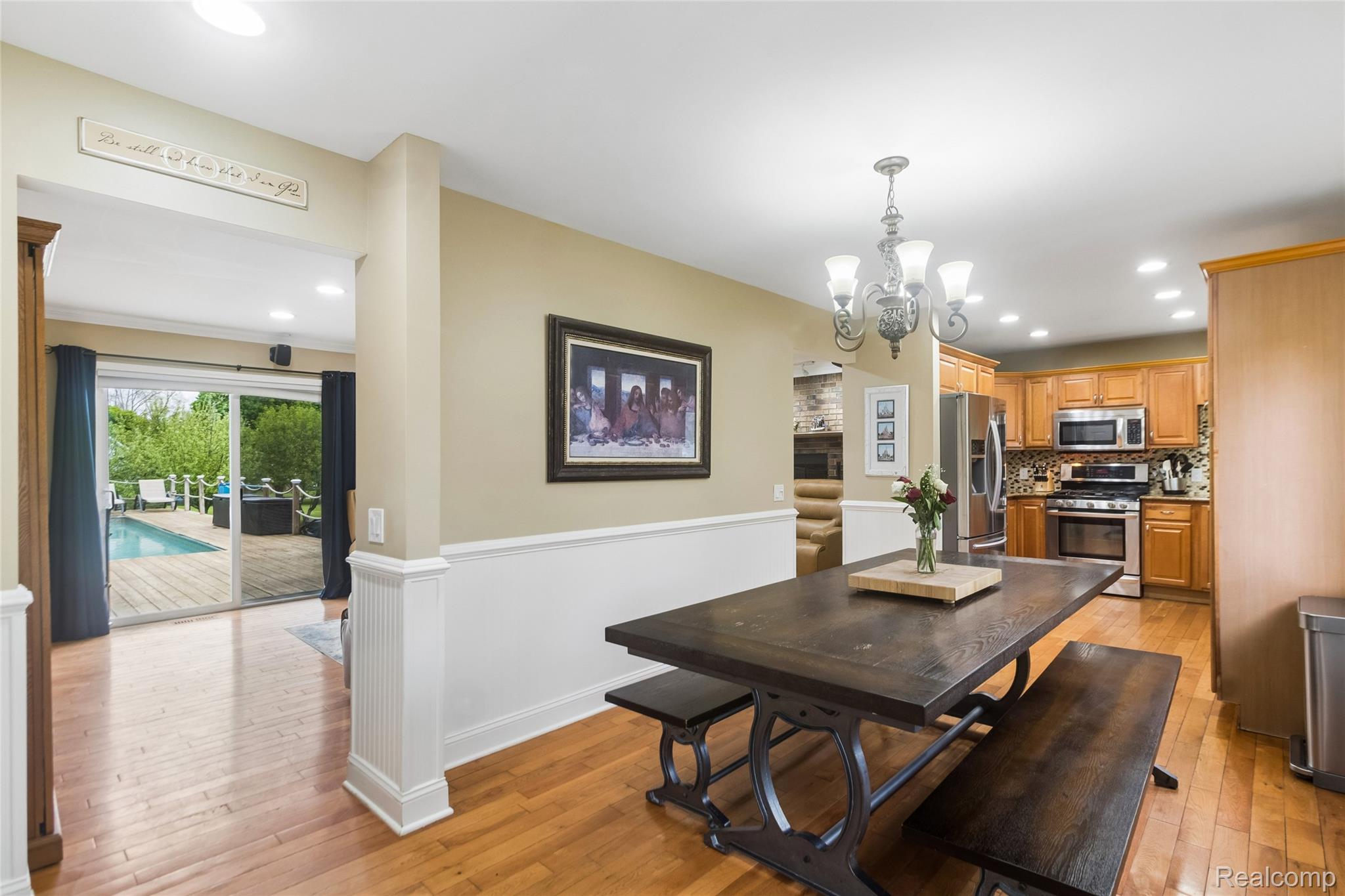 3891 Westlyn Road Lake Orion, MI 48359 - Photo 9 of 17 Dining room featuring light wood-style floors, wainscoting, and a chandelier