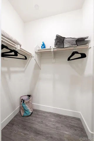 a bedroom with a bed and a lamp on table