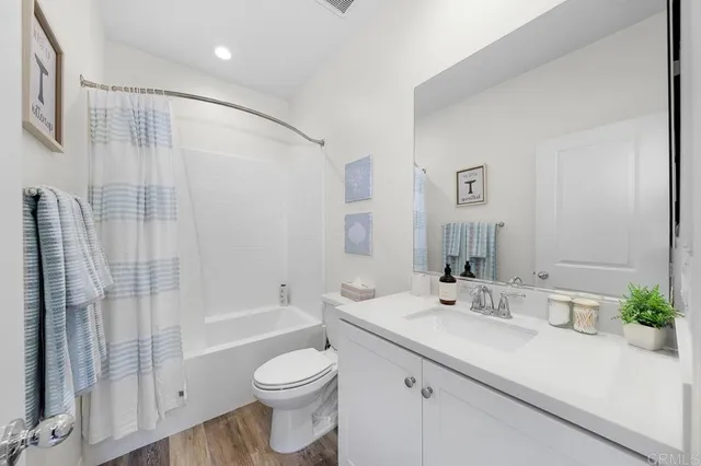 a bedroom with bed and a chandelier