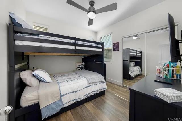 a bedroom with a bed and a ceiling fan