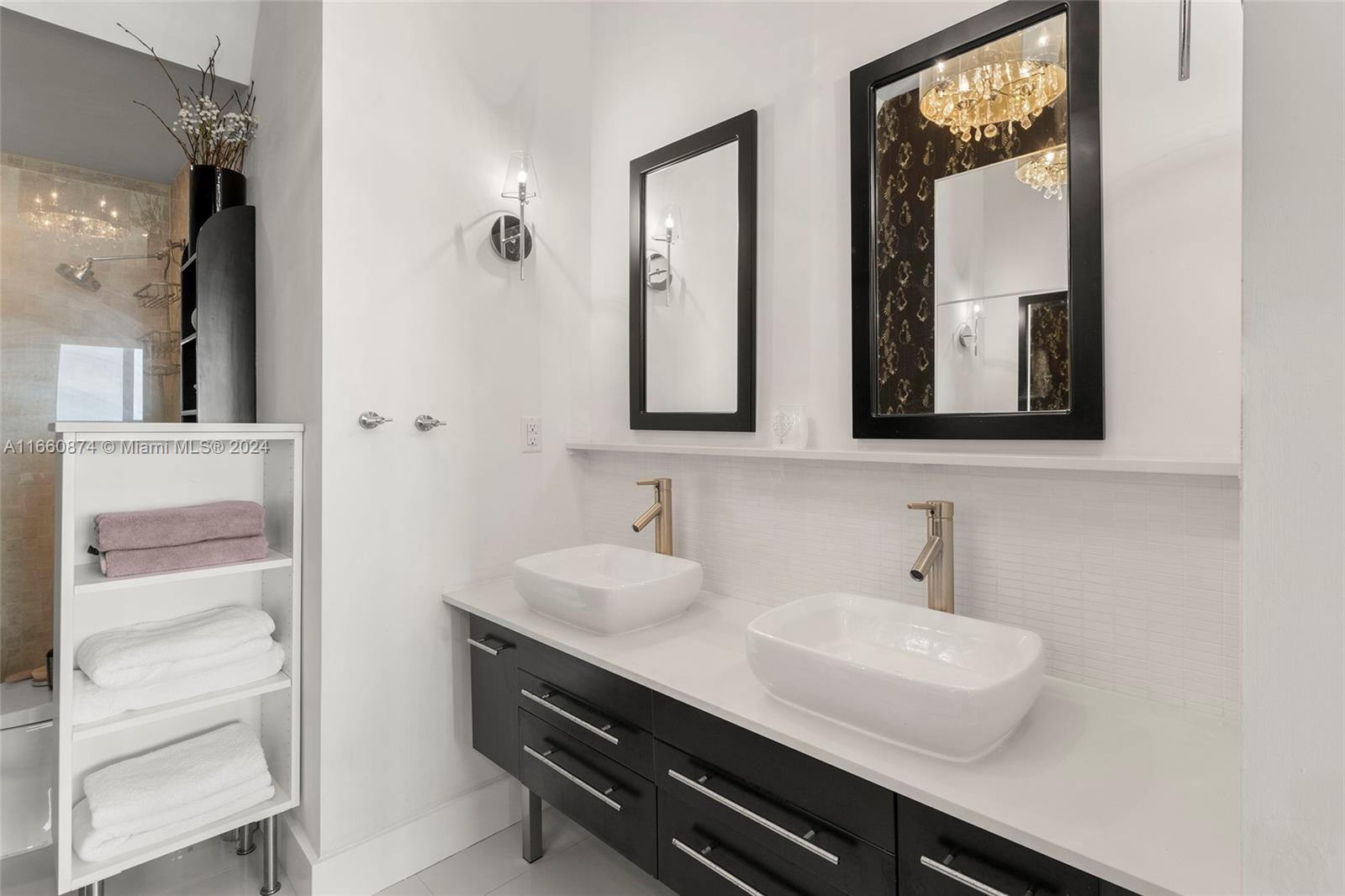 1500 Bay Road, Unit 1524S Miami Beach, FL 33139 - Photo 16 of 40 a bathroom with a sink and two mirror