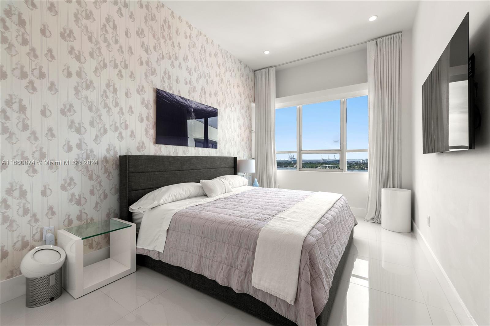 1500 Bay Road, Unit 1524S Miami Beach, FL 33139 - Photo 18 of 40 a bedroom with a bed and a window