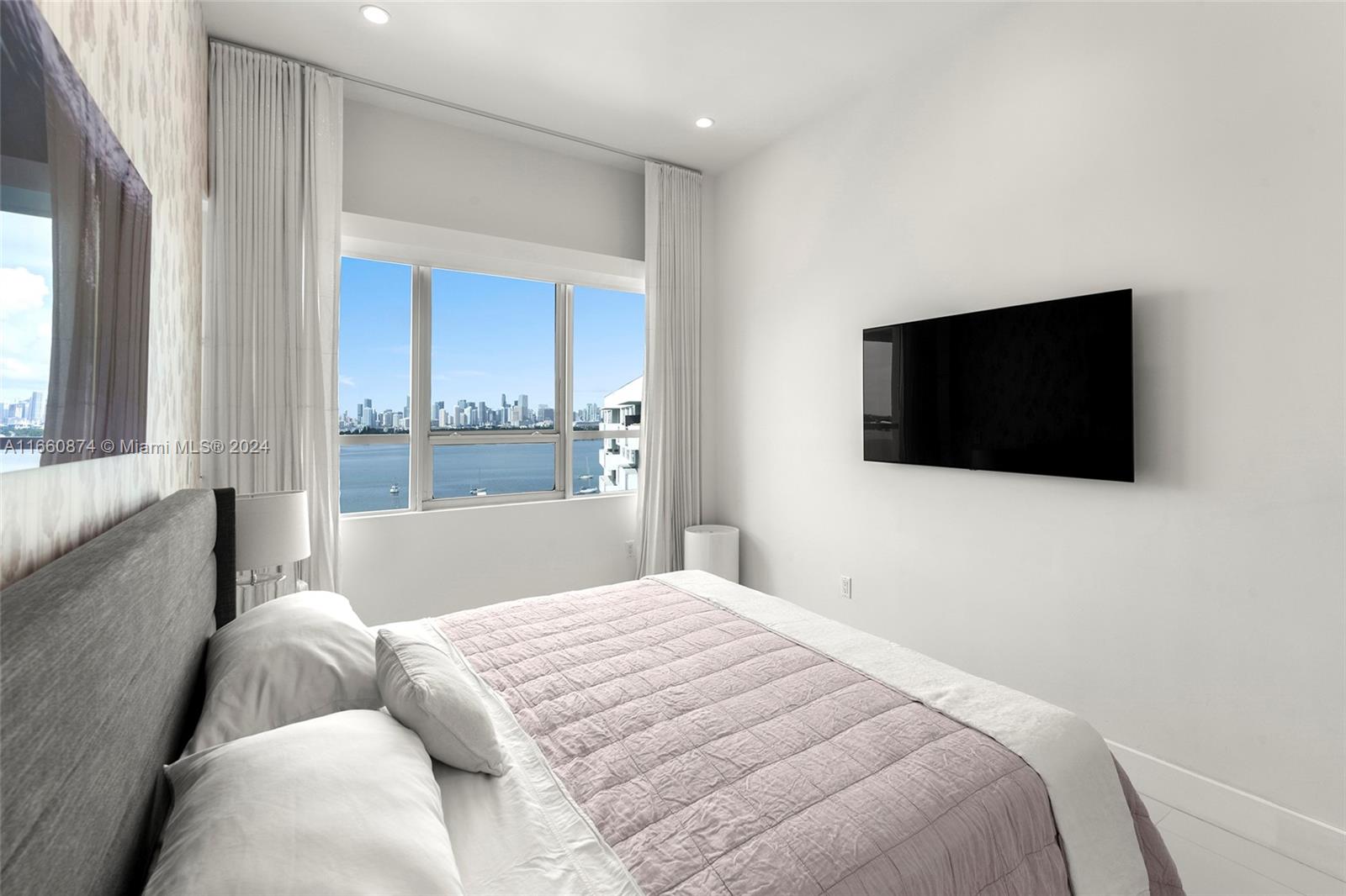 1500 Bay Road, Unit 1524S Miami Beach, FL 33139 - Photo 19 of 40 a bedroom with a bed and a flat screen tv