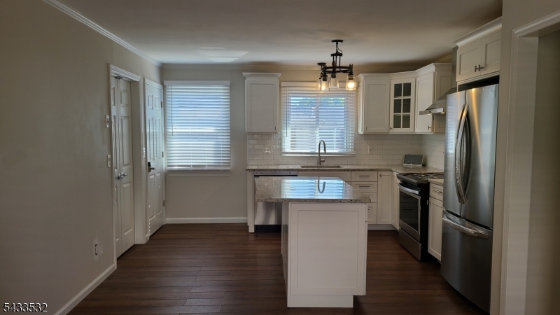 16 Ocean Street Millburn, NJ 07041 - Photo 8 of 26 a kitchen with stainless steel appliances granite countertop a refrigerator a sink dishwasher a stove and a refrigerator