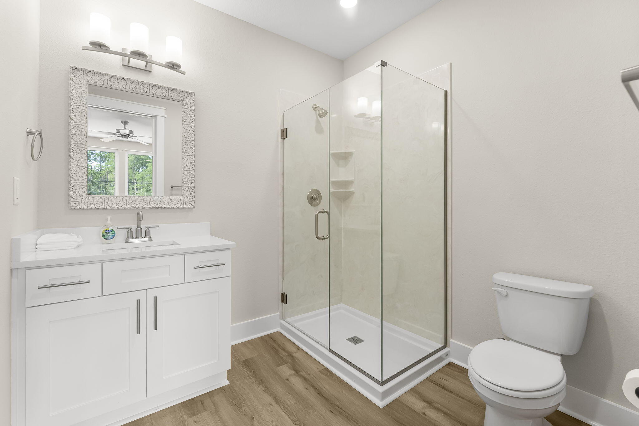 725 J D Miller Road, Unit 106 Santa Rosa Beach, FL 32459 - Photo 16 of 19 a bathroom with a shower sink vanity mirror and toilet