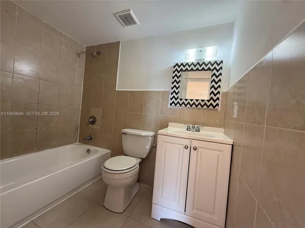 a bathroom with a toilet a sink and bathtub
