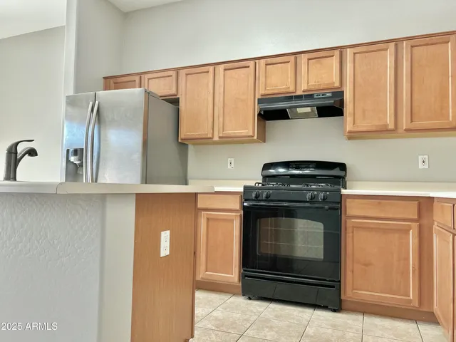 a kitchen with granite countertop a stove and a microwave