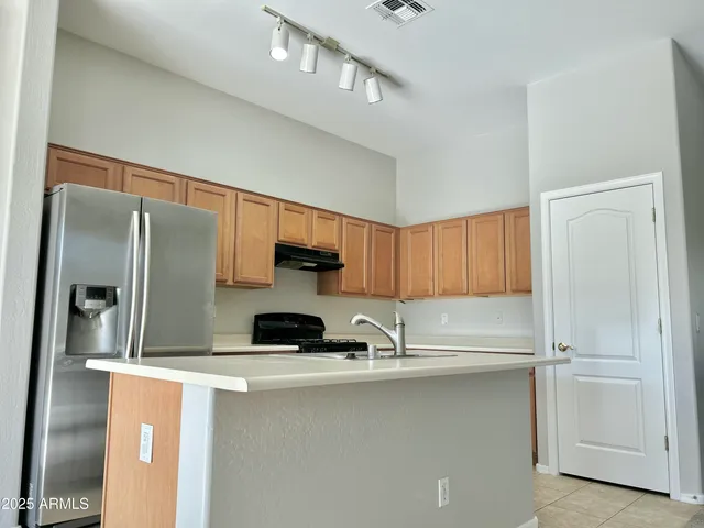 a kitchen with a refrigerator and a sink