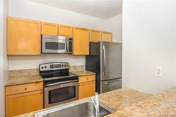 a kitchen with a refrigerator stove and microwave
