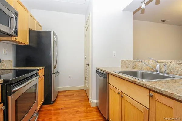 a kitchen with a sink and a refrigerator