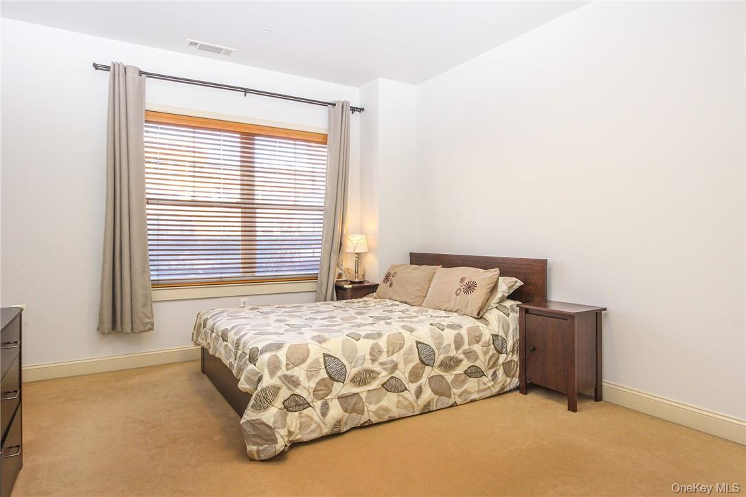 543 Main Street, Unit 211 New Rochelle, NY 10801 - Photo 15 of 22 a bedroom with a bed and a window