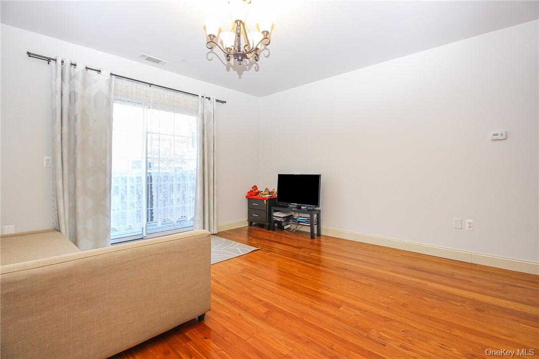 543 Main Street, Unit 211 New Rochelle, NY 10801 - Photo 5 of 22 a living room with furniture and a flat screen tv
