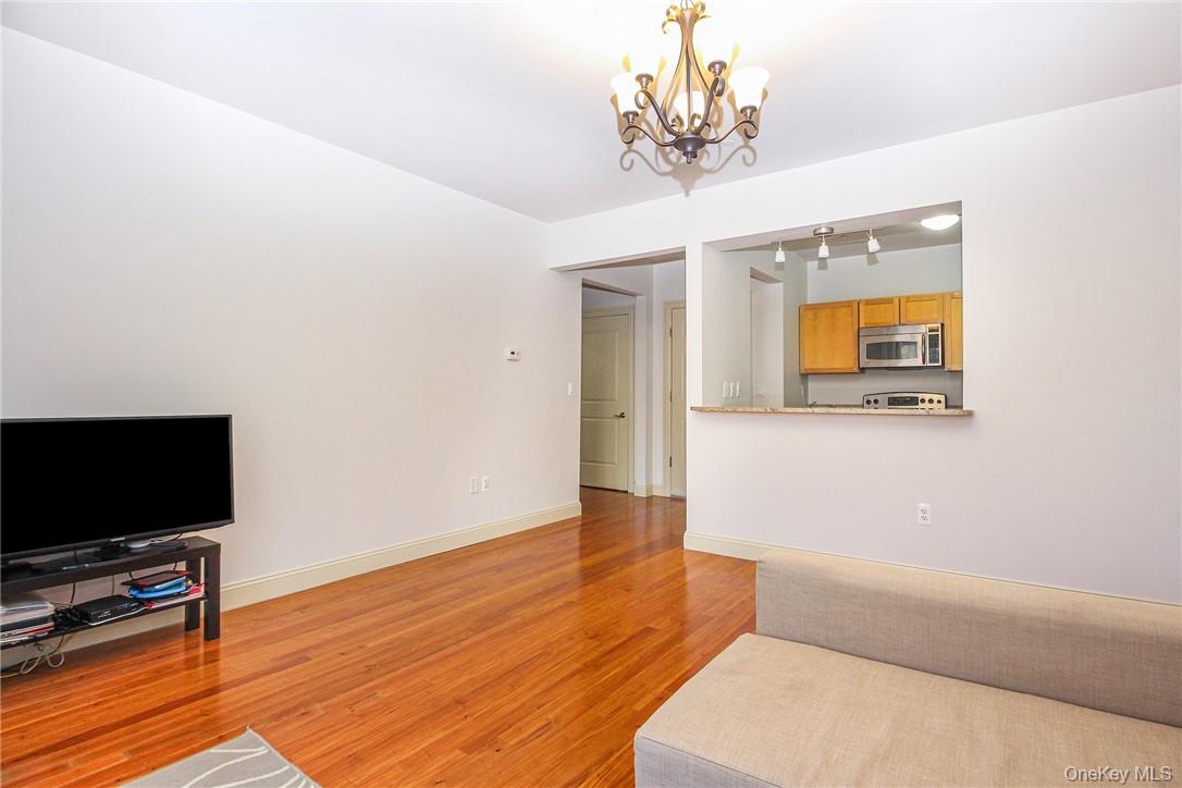 543 Main Street, Unit 211 New Rochelle, NY 10801 - Photo 8 of 22 a living room with furniture and a flat screen tv