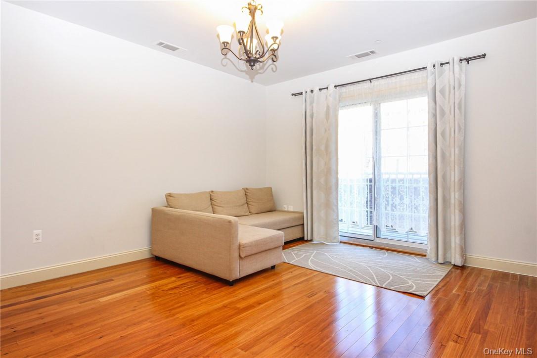 543 Main Street, Unit 211 New Rochelle, NY 10801 - Photo 9 of 22 a living room with furniture and a large window