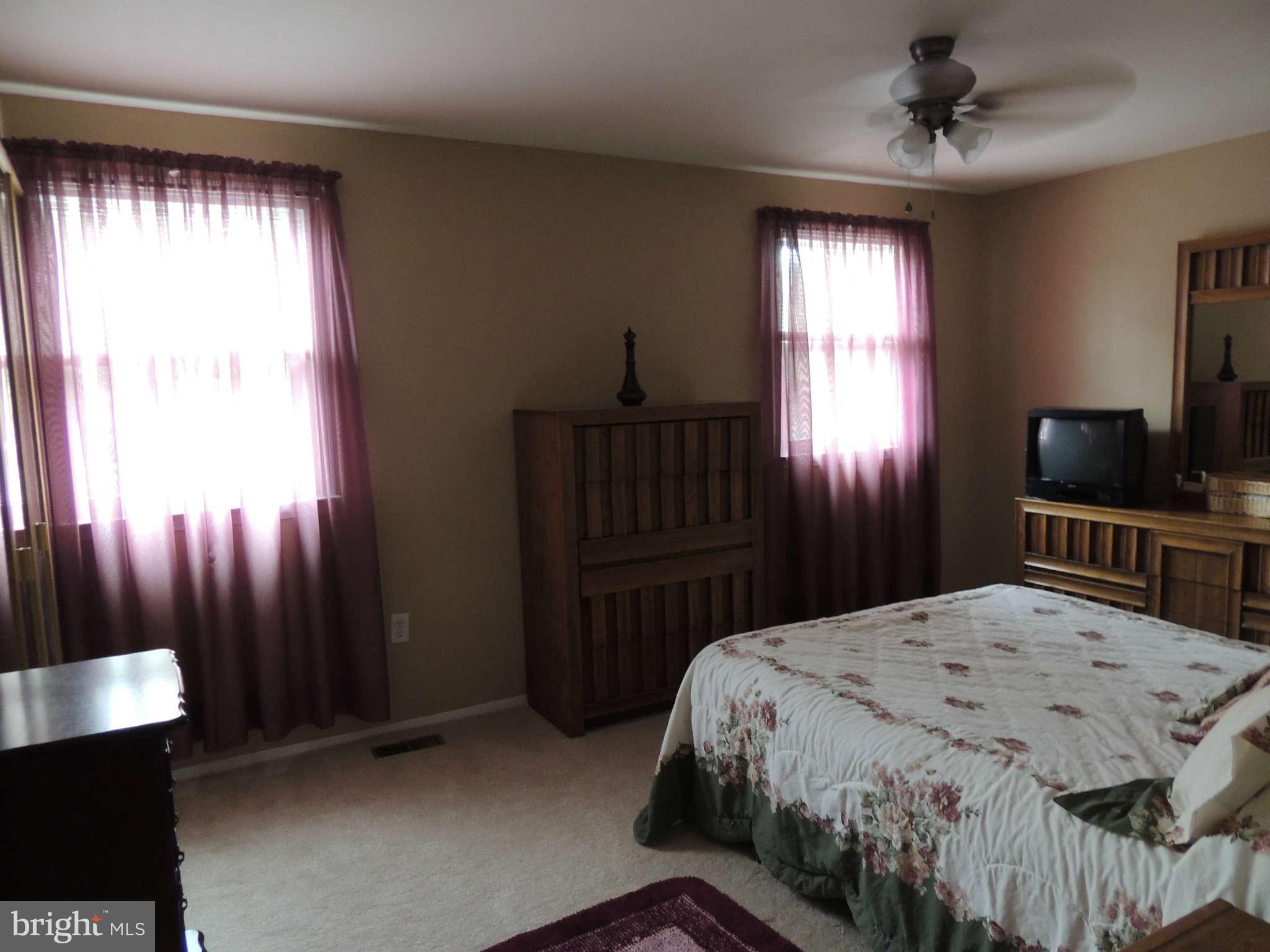 3795 Port Hope Point Triangle, VA 22172 - Photo 13 of 26 a bedroom with a bed and a chandelier